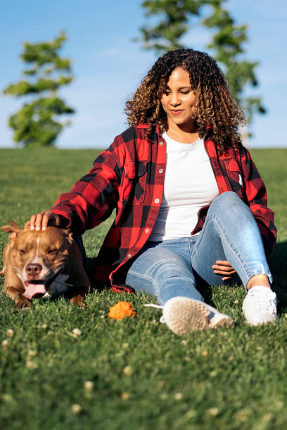 istock African Woman with Cute Dog 1436198517
