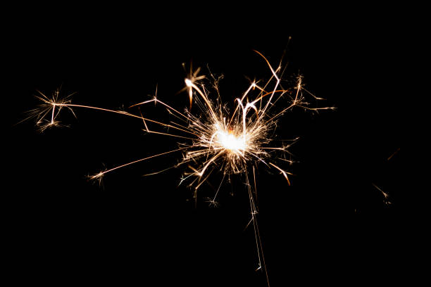 istock Burning sparkler isolated on black background. Fireworks theme. Light effect and texture. 1436199712
