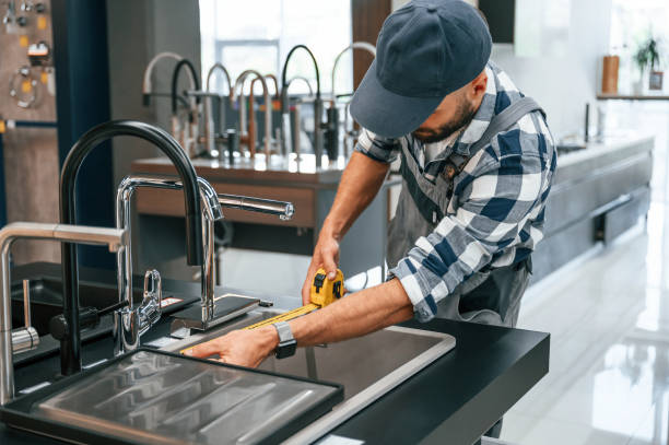 istock Works with sink. Plumber in uniform is indoors at home 1436200509