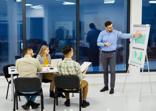 istock young business people meeting office teamwork group whiteboard presentation seminar man businessman startup project idea 1436200617