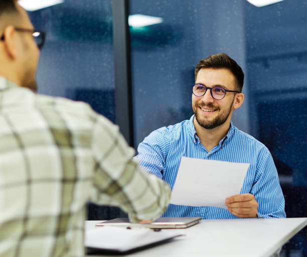 istock young business people meeting office handshake hand shake shaking hands teamwork group contract agreement black happy smiling success partnership introduction greeting businessman man introducing document applause applauding 1436200656
