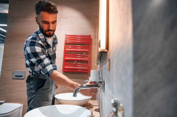 istock Checking the crane. Plumber in uniform is indoors at home 1436200727