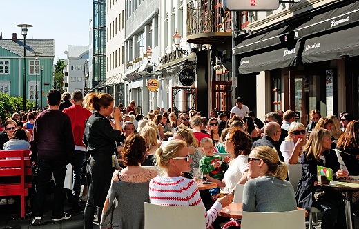 Reykjavik, Iceland – July 10, 2012: The Icelanders enjoying the good weather in an outdoor cafe in downtown Reykjavik