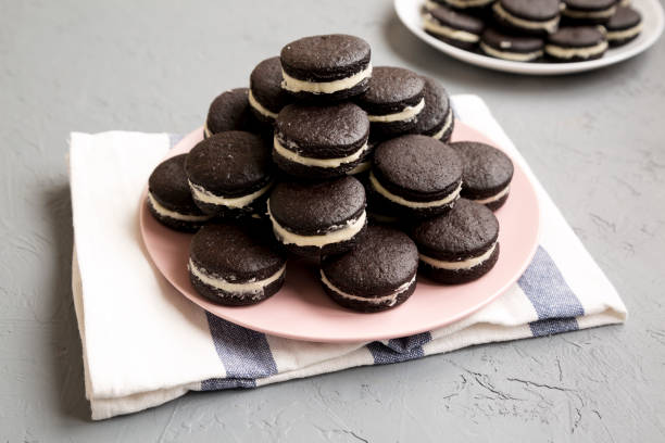 istock Homemade Oreos on a pink plate on a gray background, low angle view. 1436201865
