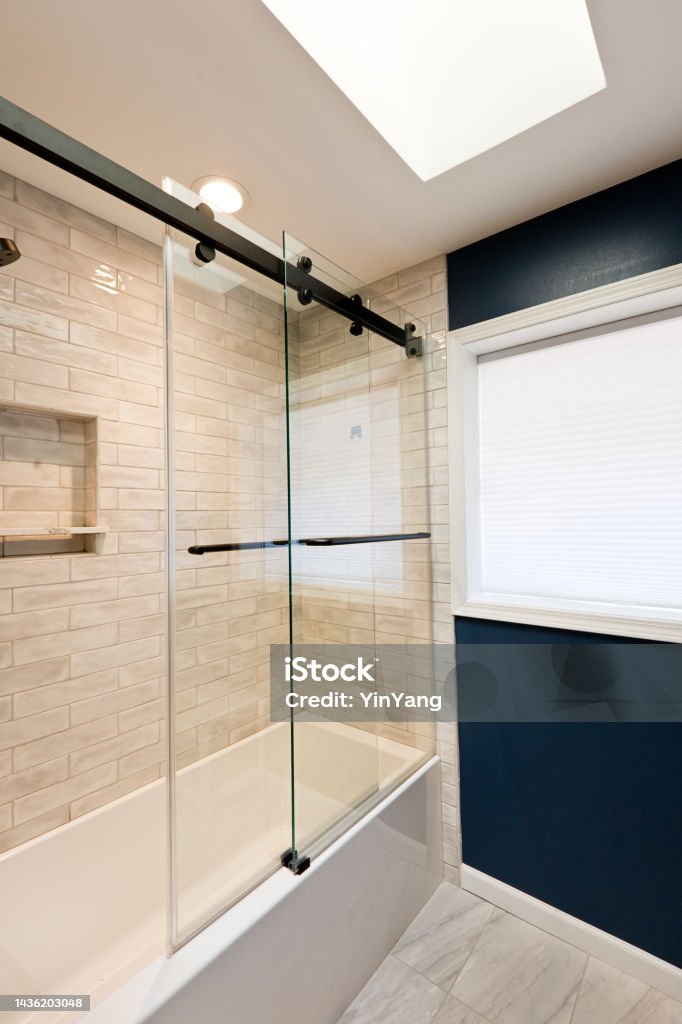 Contemporary Bathroom Design with Glass Shower Stall Enclosed Bathtub A contemporary modern bathroom design. featuring a glass enclosed bathtub Shower Stock Photo
