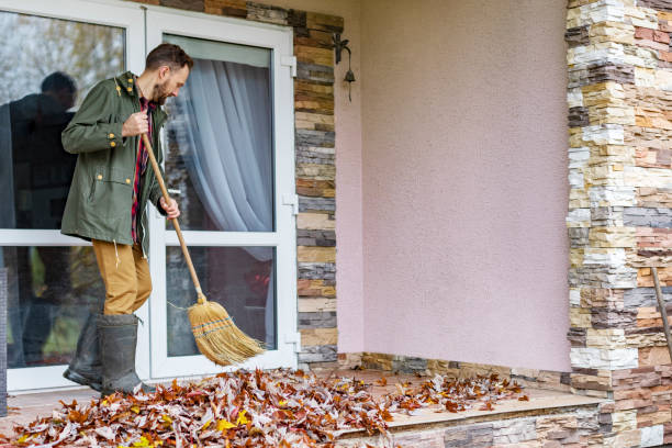 istock Adult man sweeping leaves from porch using broom 1436203795