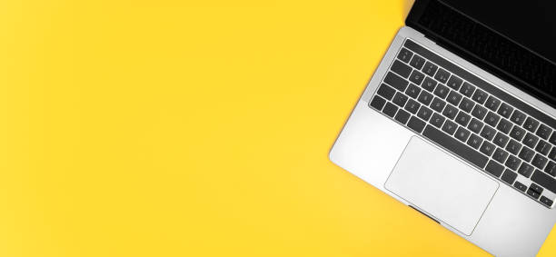 istock Top view of laptop on yellow background. 1436204552