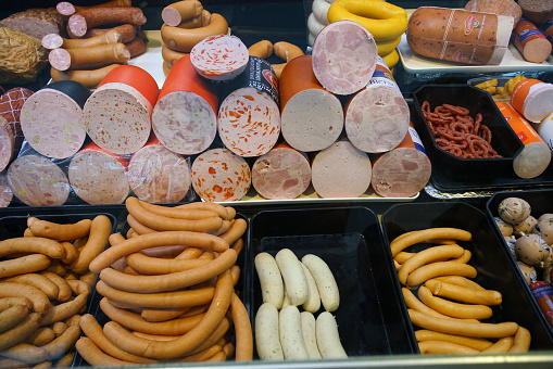 09-16-2022   Hanover, Germany. sausages for heating (narrow) or wide for sandwiches of different brands in a  German supermarket window