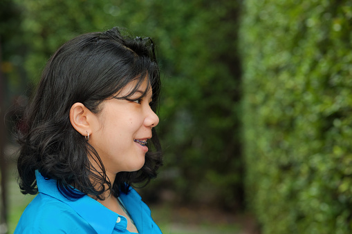 Profile view of young Thai woman