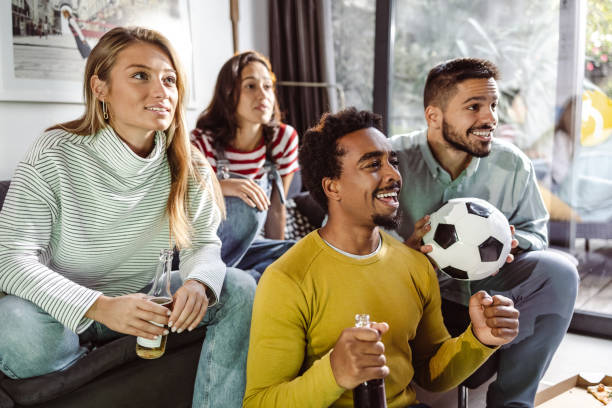 istock Friends watching sport on TV 1436208964