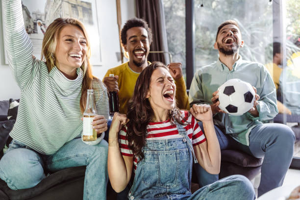 istock Friends at home watching sports match 1436209002