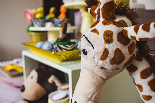 Stuffed giraffe as decoration of child birthday party. Child birthday party.