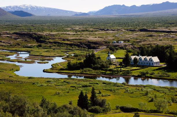 istock Valley with lush greenery and Thingvallavatn lake surrounded by mountains under blue sky, Iceland 1436210380