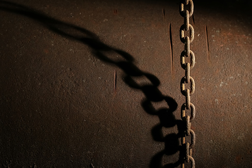 rusty chain hangs vertically