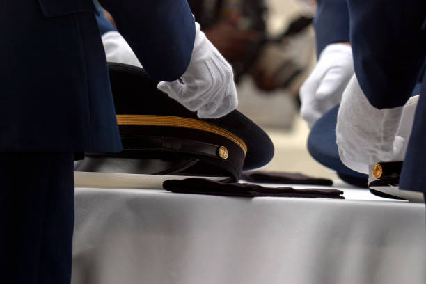 istock White Gloves Placing Peaked Caps at the Table Ceremony 1436212134