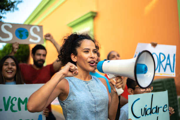 istock Mid adult woman leading a protest using a megaphone 1436218268