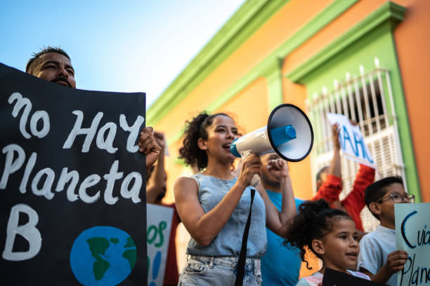 istock Mid adult woman leading a protest using a megaphone 1436218329