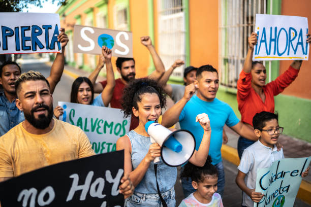 istock Mid adult woman leading a demonstration using a megaphone 1436218538