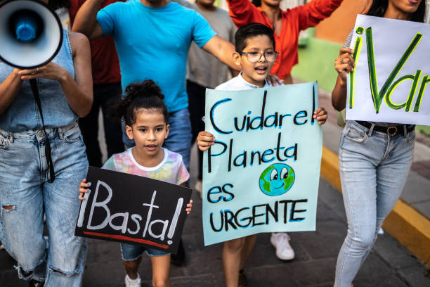 istock Children walking while holding signs on a protest outdoors 1436218547