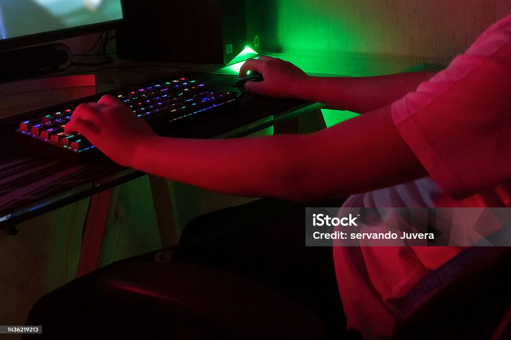 person playing on the computer using the keyboard, online games and pc games Addiction Stock Photo person playing on the computer using the keyboard, online games and pc games Addiction Stock Photo