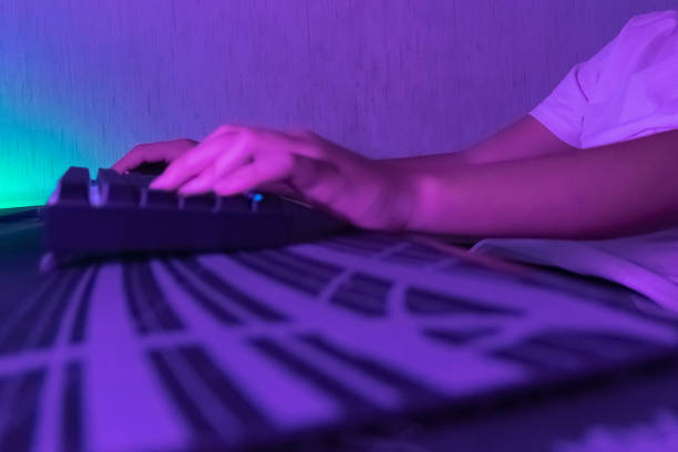 istock person playing on the computer using the keyboard, online games and pc games 1436219280