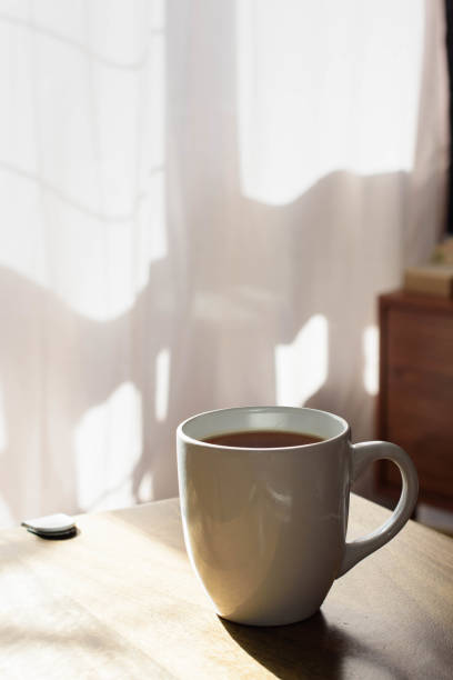 istock Tea or coffe mug on a table in a sunny morning 1436220783