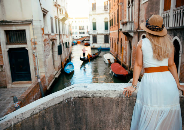 istock Female tourist Looking at Venice canal 1436221165