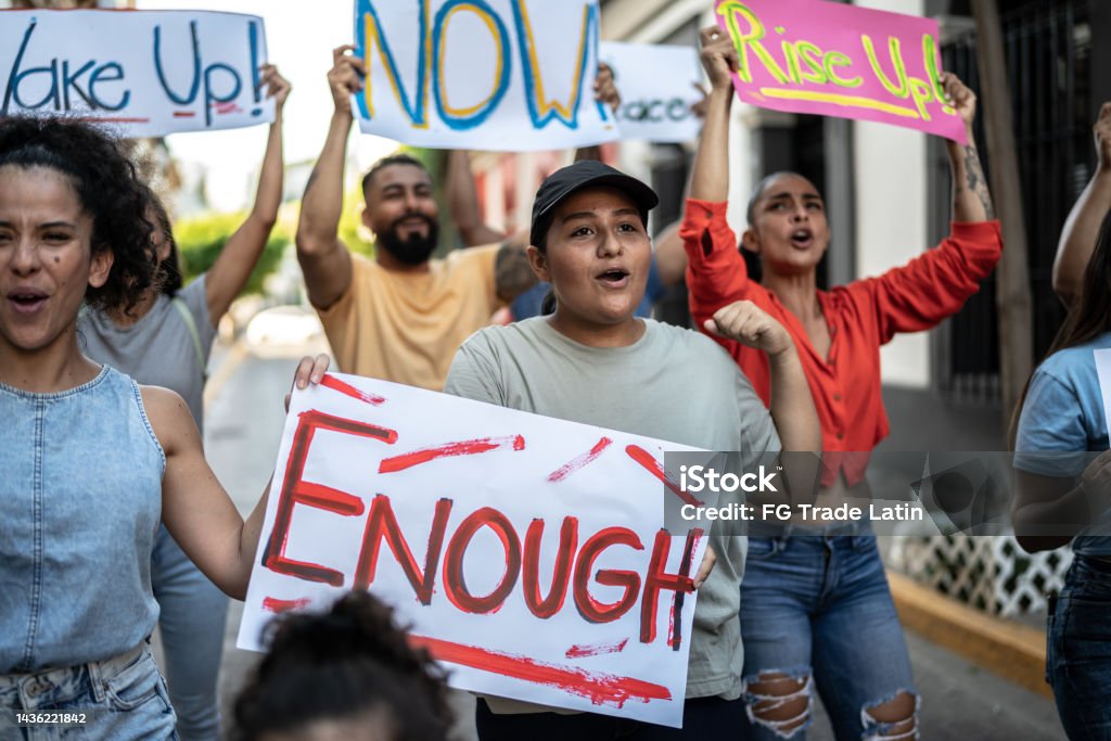 Young woman holding signs during on a demonstration outdoors Climate Activist Stock Photo