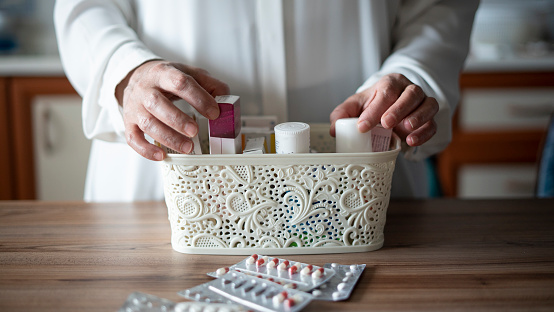 Close-up Adult woman organizing first aid basket