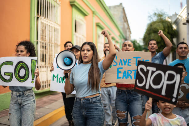 istock Mid adult woman leading a protest using a megaphone 1436222136
