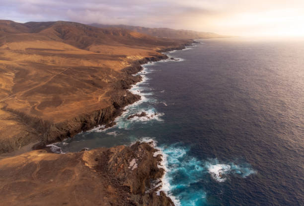 istock Sunset on the coast with mountains 1436222151