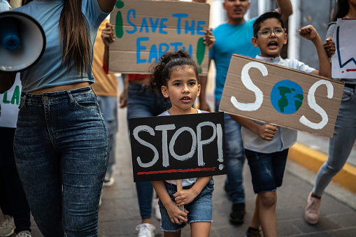 Children holding signs about the environment at a protest