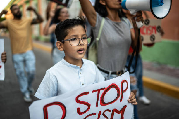 Child boy holding a sign on a protest