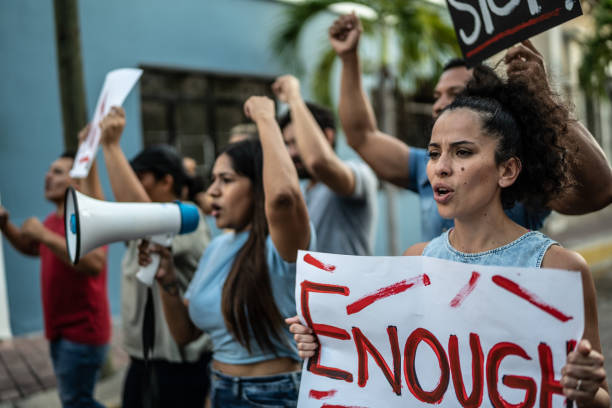 istock Protesters walking while holding signs on a protest outdoors 1436225785