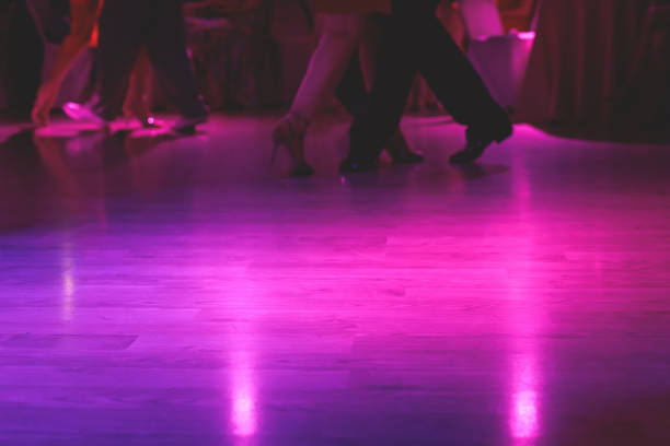 dancing shoes of a couple, couples dancing traditional latin argentinian dance milonga in the ballroom, tango salsa bachata kizomba lesson, festival on a wooden floor, purple, red and violet lights - polka dancing imagens e fotografias de stock