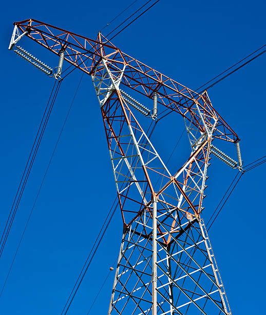 Electricity Pylon Against Blue Sky Electricity pylon against blue sky. buzbuzzer energy cable steel cable stock pictures, royalty-free photos & images