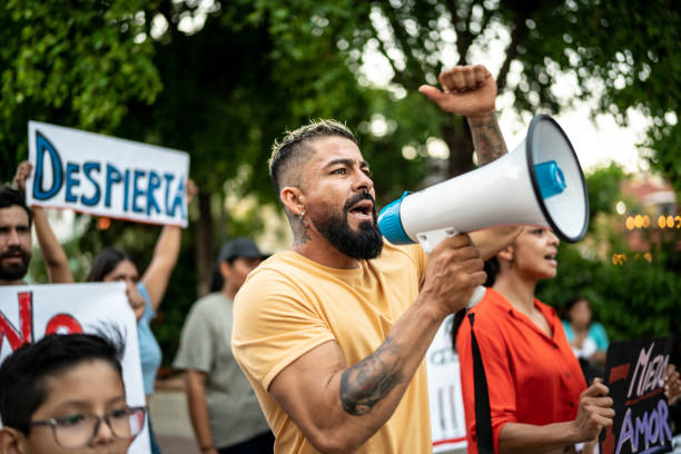 istock Mid adult man leading a demonstration using a megaphone outdoors 1436229946