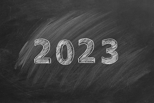 Hand drawn text 2023 on blackboard. Happy New Year.