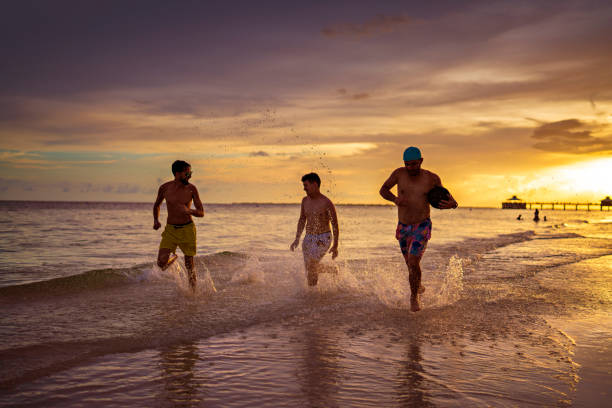 istock Latin guys running on the beach in Ft Myers 1436234770