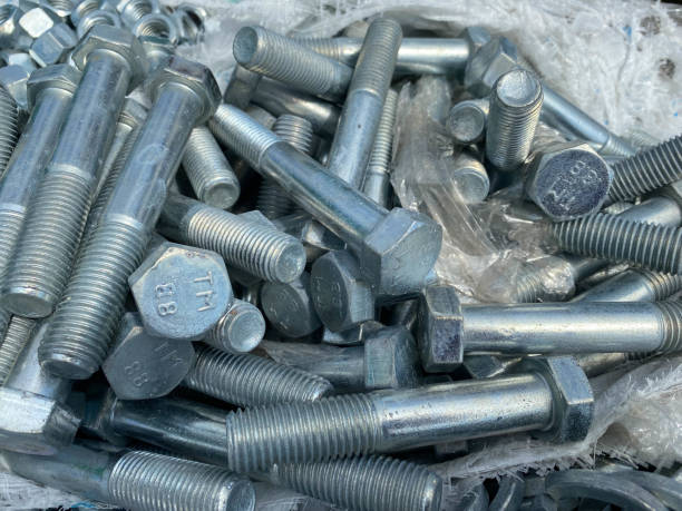 Background, texture of many metal small iron bolts and stainless steel fasteners, fittings and mitiz Background, texture of many metal small iron bolts and stainless steel fasteners, fittings and mitiz. zinced steel stock pictures, royalty-free photos & images