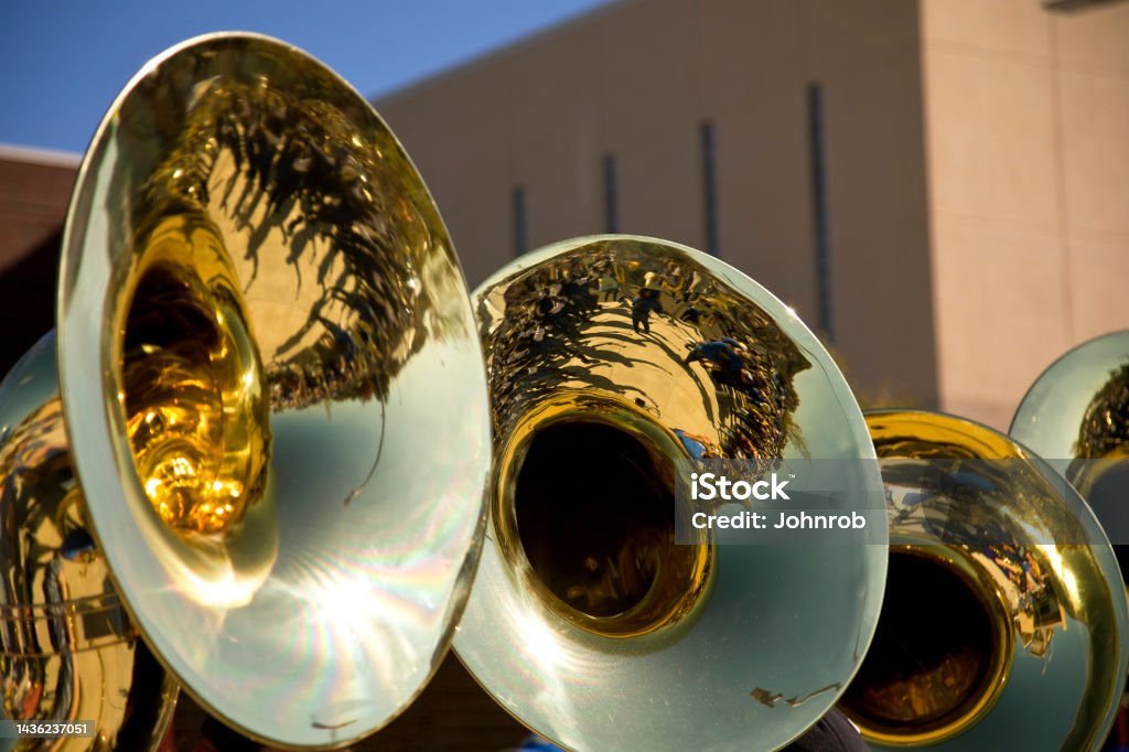 Marching band reflection in a tuba Marching band performance Group at college football game. Adults Only Stock Photo