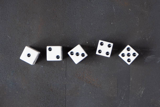 istock White dice disorganized over black background. 1436239991