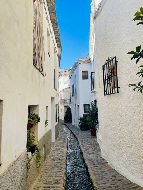 istock Narrow street with a small water channel 1436245066