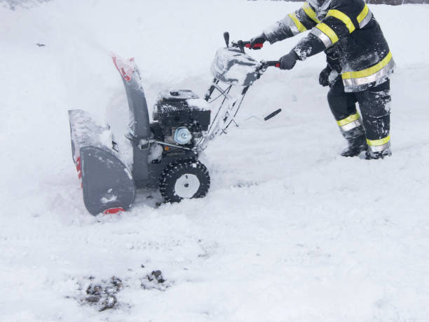 istock a snow blower is clearing a road 1436246866