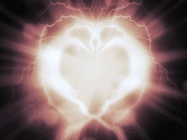istock 3d illustration of heart shaped light shining in the dark 1436247610