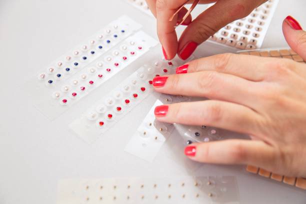 istock Female hands applying Magnetic Therapy Ear Patch Auricular Auriculotherapy 1436249454