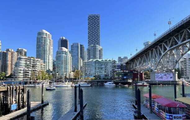 Bridge to greenville and water bus passing under the bridge Nature Canada Vancouver Pacific Ocean Pier and pillars on the pier Granville Island aquabus Skyscrapers in the background Bridge to greenville and water bus passing under the bridge Nature Canada Vancouver Pacific Ocean Pier and pillars on the pier Granville Island aquabus Skyscrapers in the background 09.2022 Canada granville island stock pictures, royalty-free photos & images