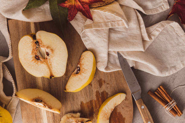 Ripe whole and sliced quinces. Fresh fruit for preparing recipes with cinnamon and lemon. An essential ingredient for a healthy diet