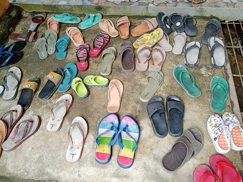 South Borneo, Indonesia - September 21, 2022: two pairs of sandals placed on the terrace of the mosque