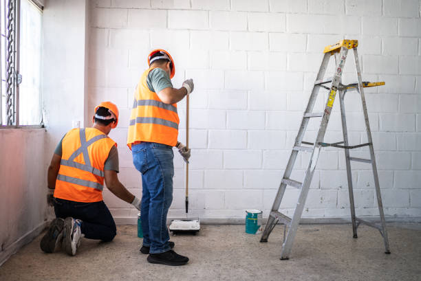 istock Young painters / construction workers painting a wall indoors 1436256945